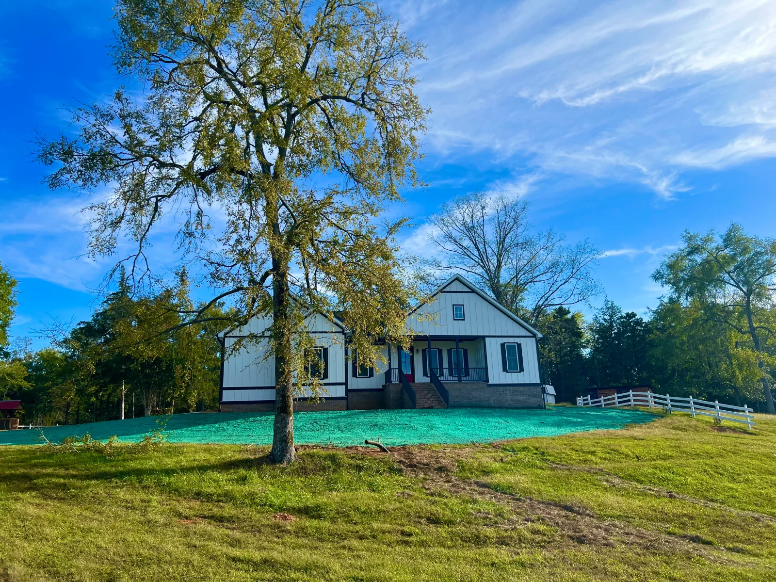 Professional hydroseeding equipment applying seed and erosion control materials to a prepared slope in South Carolina